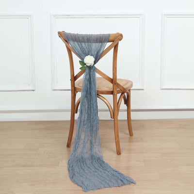 Blue textured chair scarf with a flower accent on a wooden chair.