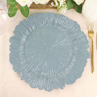 Blue decorative plate with a textured design on a table setting.