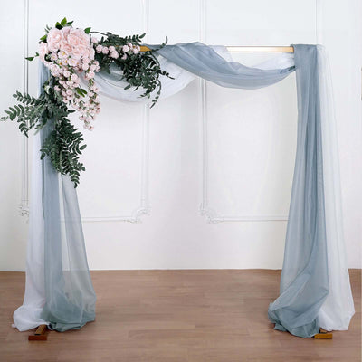 Wedding arch with floral accents and flowing drapes