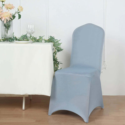 Elegant blue chair cover draped on a chair at a dining table.