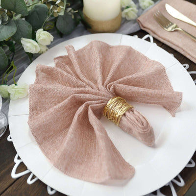 Elegant blush linen napkin styled on a white plate with a gold ring.