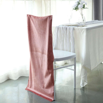 Elegant pink chair cover draped on a white chair in a bright, airy setting.