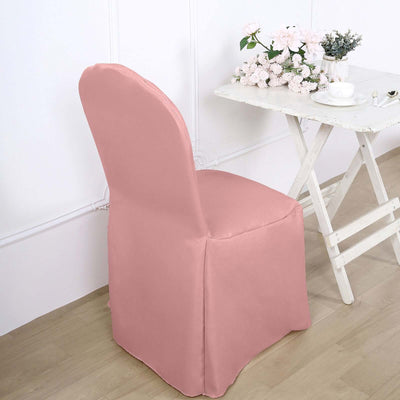 Pink chair cover on a chair beside a table with flowers and tea.