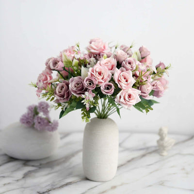 Bouquet of pink roses in a white vase on a marble surface.