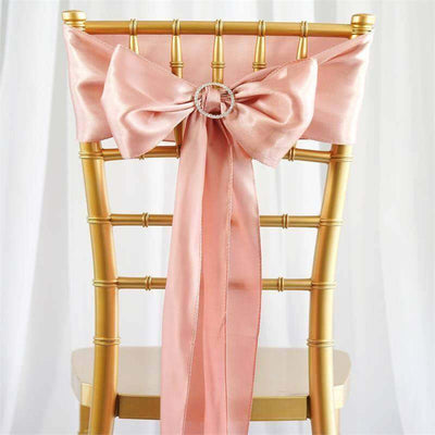 Gold chiavari chair with pink satin bow and rhinestone accent.