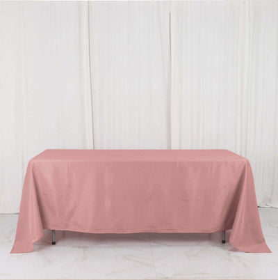 Pink tablecloth draped over a table in a studio setting.