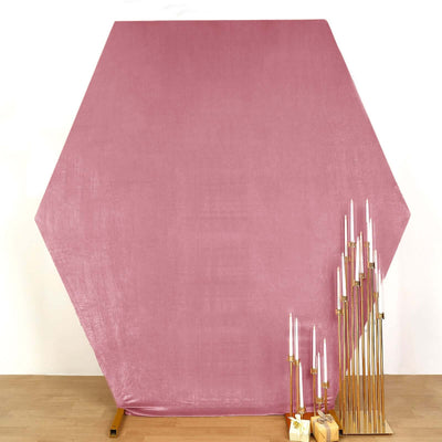 Pink hexagonal backdrop with gold candle holders and white candles