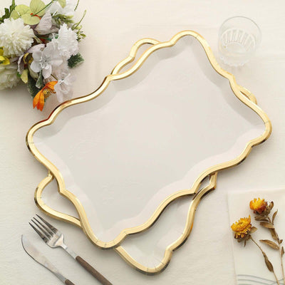 Elegant white serving trays with gold trim on a table setting.