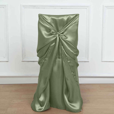 Green satin chair cover with a bow detail on a plain backdrop.