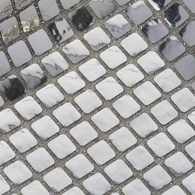 Textured silver and white geometric tile pattern.