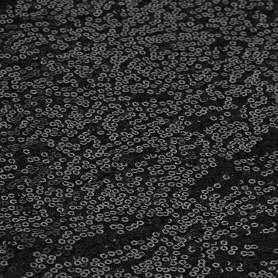 Black sequined fabric texture with intricate detailing.