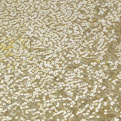 Gold sequin fabric texture with shimmering details.