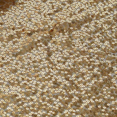 Gold sequin fabric texture with shiny circular sequins.