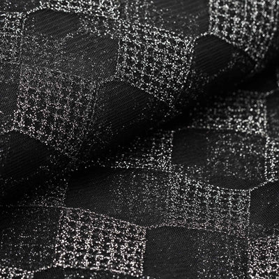 Textured black fabric with a hexagonal pattern and metallic accents.