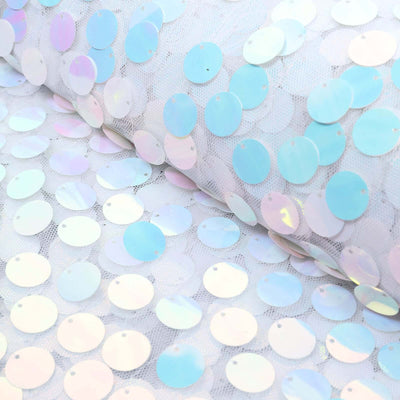 Iridescent sequin fabric with circular sequins on a light background.
