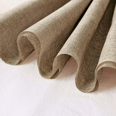Textured beige fabric draping elegantly in soft folds.