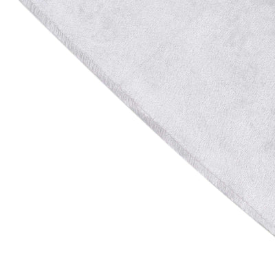 Soft white microfiber towel corner on a plain backdrop
