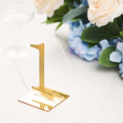 Gold number one table centerpiece with elegant floral background.