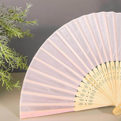 Elegant pink fabric hand fan with wooden handle, displayed against a neutral background.
