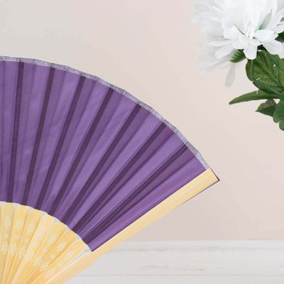 Purple paper fan with a yellow handle against a soft pink background.
