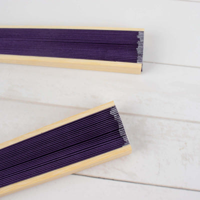 Purple pleated window shades with wooden frames