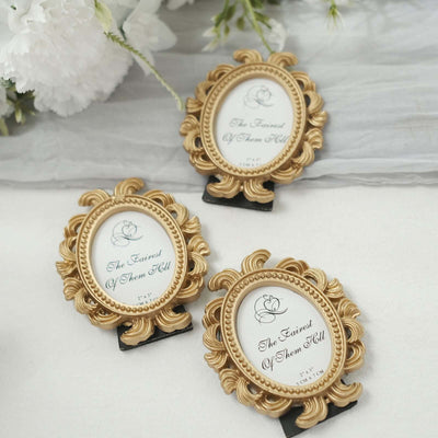 Gold ornate picture frames with decorative details, arranged on a soft backdrop.