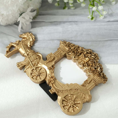 Gold carriage-shaped decorative mirror with floral accents.