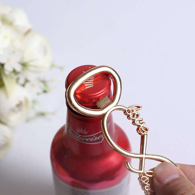Gold infinity love bottle opener in use on a red beer bottle.