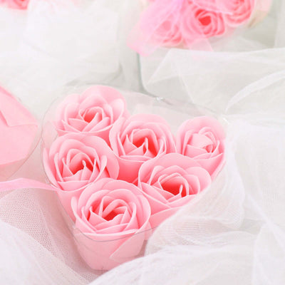 Pink rose soap flowers in a heart-shaped box.