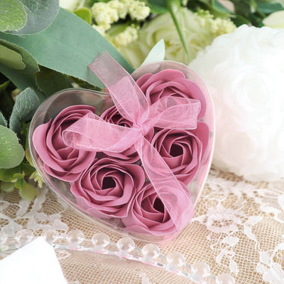 Pink rose soap flowers in a heart-shaped box with a ribbon.