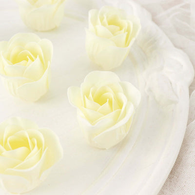 White rose-shaped candles arranged on a decorative plate.