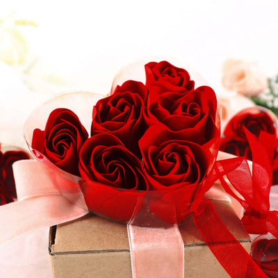 Red rose bouquet in a heart-shaped box with ribbon accents.