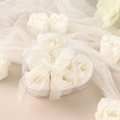 Heart-shaped box of white artificial roses with ribbon.