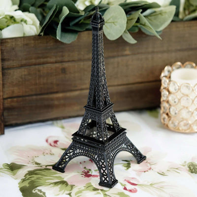 Black Eiffel Tower model on floral tablecloth.