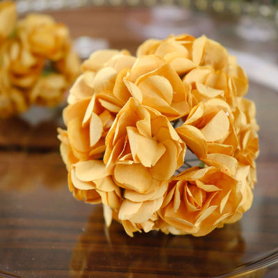 Yellow floral bouquet made of paper petals on a wooden surface.