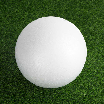 White foam ball on green grass background.
