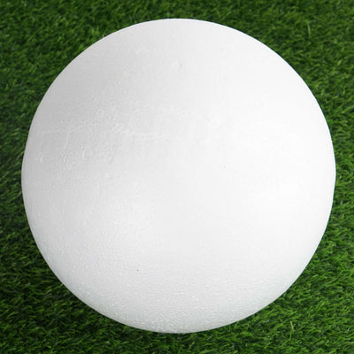 White foam ball on grass surface.