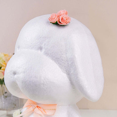 White dog-shaped decor with pink flower accents.