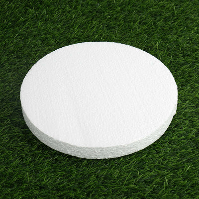 White round foam disc on green grass background.