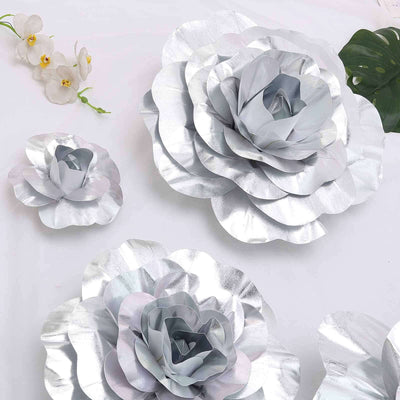 Silver paper flower wall decor in various sizes on a white backdrop.