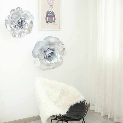 Silver floral wall decor in a modern room with a cozy chair.