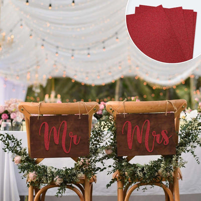 "Elegant wedding chairs with 'Mr' and 'Mrs' signs in festive setting."