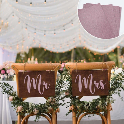 Mr and Mrs wedding chair signs with elegant decor and lights in the background.
