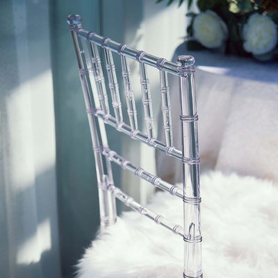 Clear acrylic chiavari chair back on soft white fur