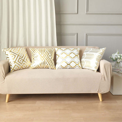 Beige sofa with decorative gold-patterned cushions in a stylish living room setting.