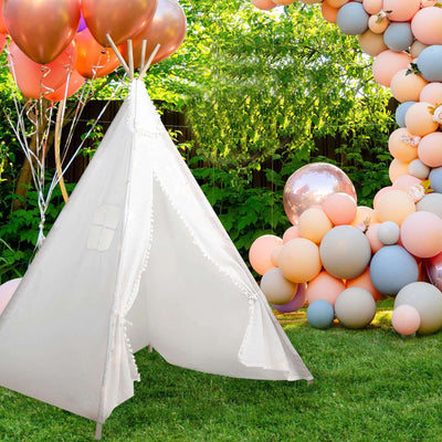 Kids' play tent in a garden setting with colorful balloons.