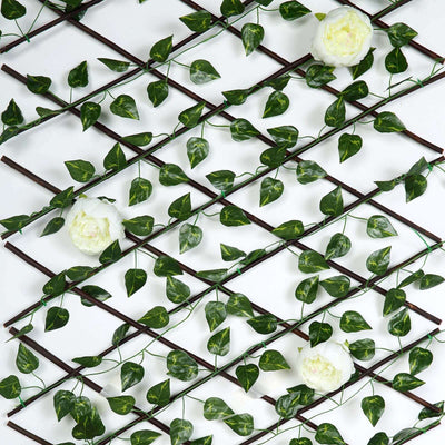Decorative trellis with green leaves and white flowers.