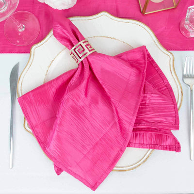 Pink satin napkin elegantly displayed on a decorative plate.