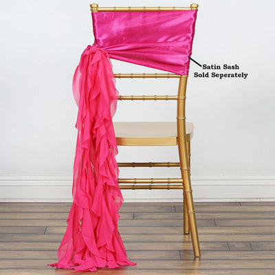 Gold chiavari chair with pink satin sash draped elegantly.
