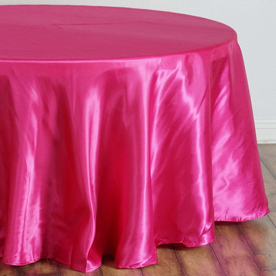 Pink satin tablecloth draped over a round table.